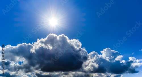 Blue sky and sun above the clouds - cloudy sky and sun
