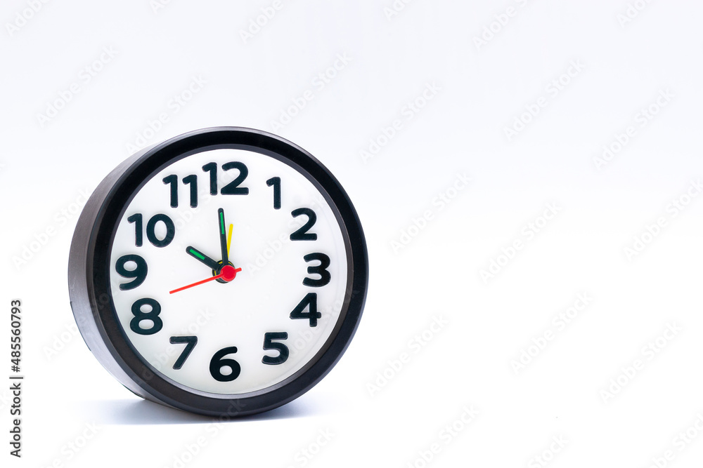 Black alarm clock isolated on white background. The clock set at 10 o'clock. Black alarm clock isolated on white background. The clock set at 10 o'clock.