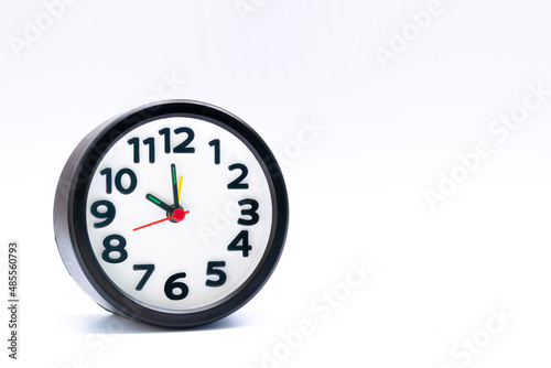 Black alarm clock isolated on white background. The clock set at 10 o'clock. photo