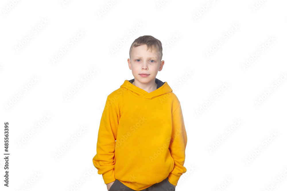 A blond Caucasian boy of 7 years old in a yellow hoodie confidently looks straight ahead. Isolate of a child on a white background A blond Caucasian boy of 7 years old in a yellow hoodie confidently looks straight ahead. Isolate of a child on a white background