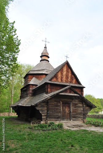 An old wooden church in Ukraine. Rural landscape with a church. Wooden Ukrainian church. The green landscape of the countryside. Kiev. Ukraine.