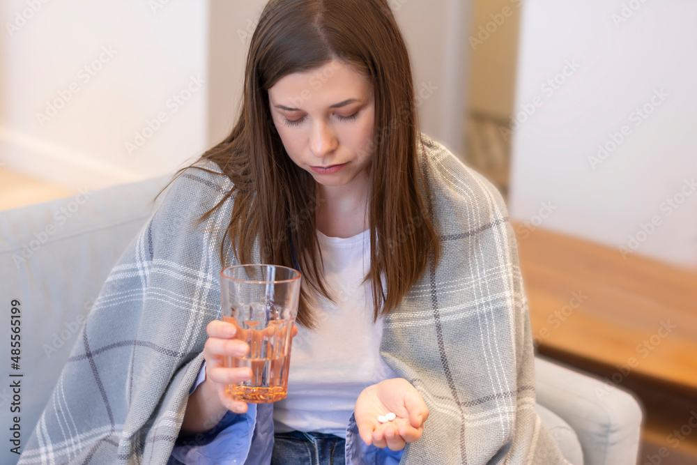 Cropped woman takes immunity pills and drinks a glass of water doctor's prescription treatment Cropped woman takes immunity pills and drinks a glass of water doctor's prescription treatment