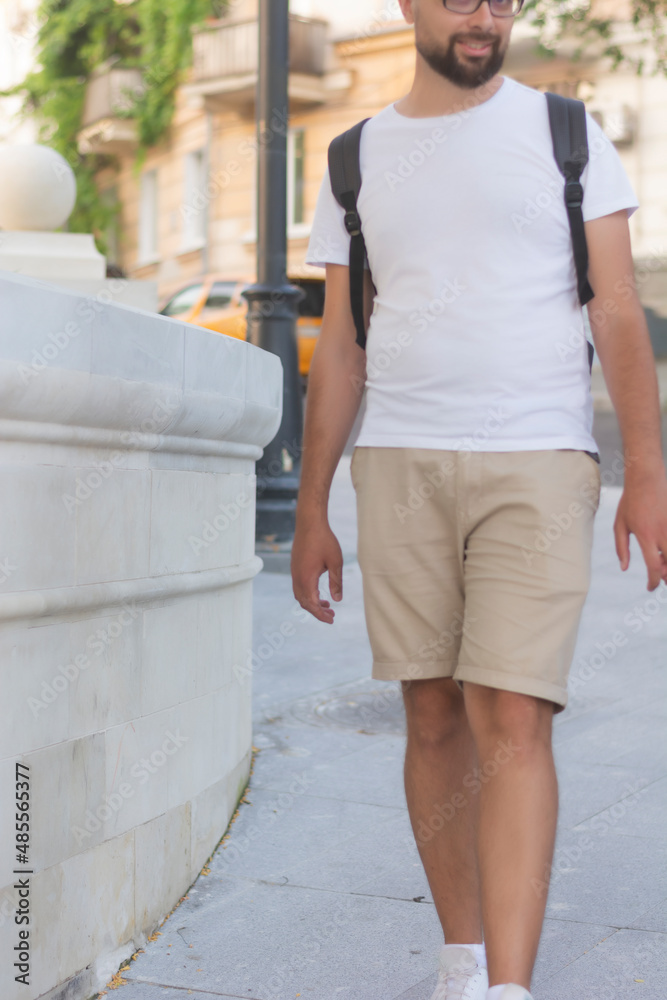 Fotka „No face man in white t-shirt and beige shorts with a black backpack  mock-up bella canvas copy space“ ze služby Stock | Adobe Stock