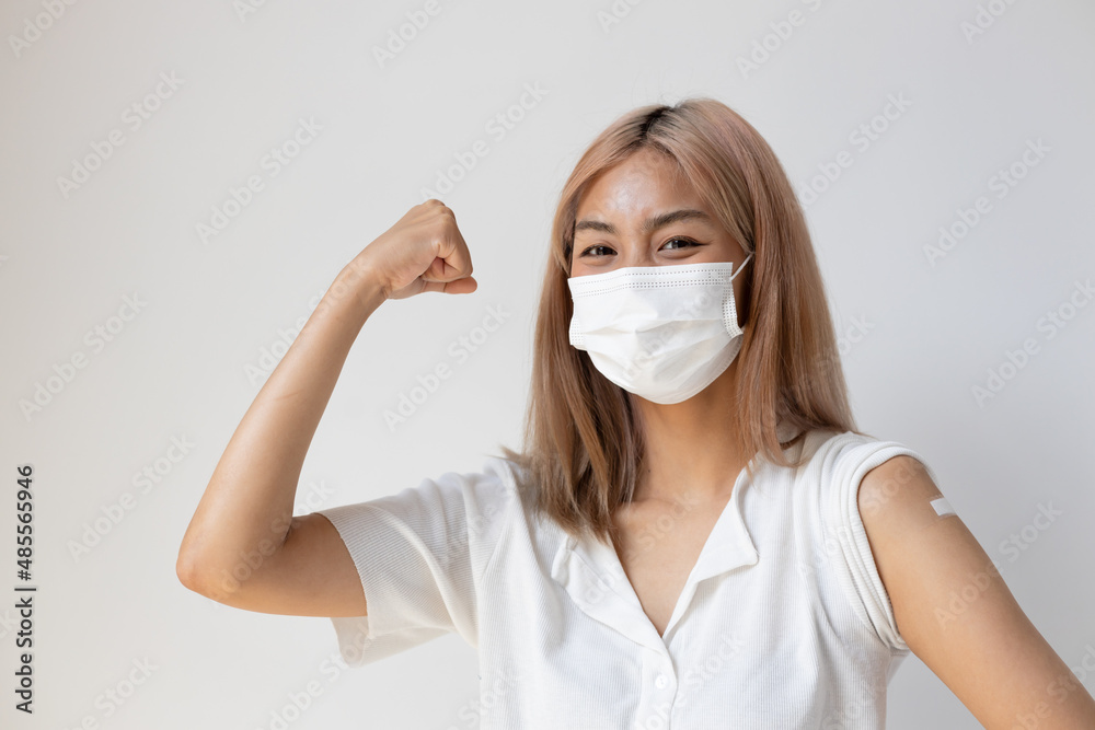 Healthy and strong asian woman getting vaccinated immunity by vaccination program, concept of recommended dose of inoculation, vaccine booster shot, vaxxed woman with approved vaccine Healthy and strong asian woman getting vaccinated immunity by vaccination program, concept of recommended dose of inoculation, vaccine booster shot, vaxxed woman with approved vaccine