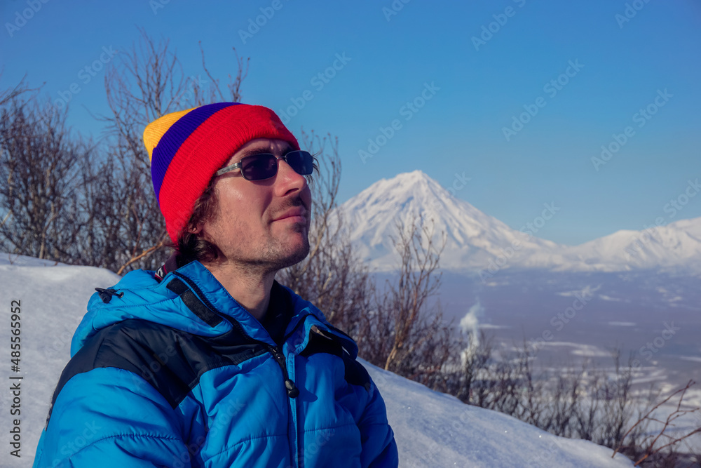 A guy on a mountain overlooking the volcanoes of Kamchatka
