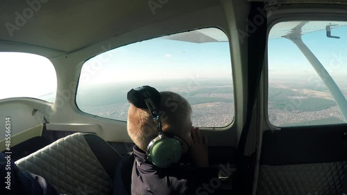 Flying in a small light plane. A man father with a boy child in the cabin of light small aircraft airplane