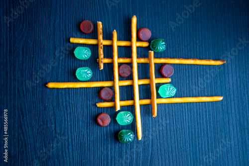 Cracker sticks lattice with mints lollipops and marmalad photo