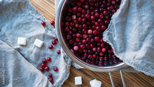 Cranberry in a bowl with beetroot sugar. Food preparation n a table in the kitchen photography. photo