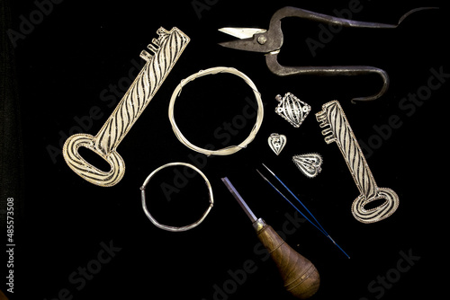 The process of making silver filigree. Manufacturing and manufacturing, factory, casting craft design, embroidered precious silver jewelry, filigree, jeweler in workshop. silver filigree equipment