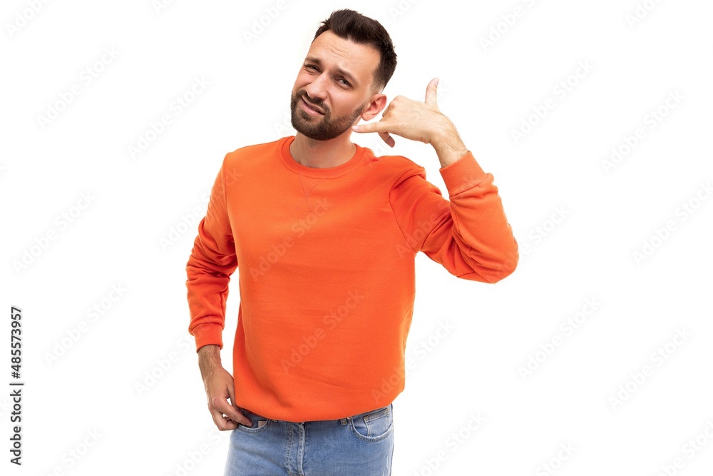 a man in orange clothes on a white background with a gesture shows Call me
