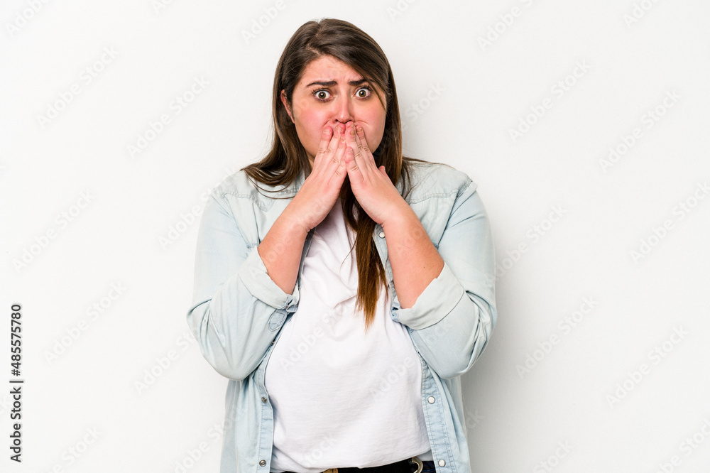 Young caucasian overweight woman isolated on white background covering mouth with hands looking worried. Young caucasian overweight woman isolated on white background covering mouth with hands looking worried.