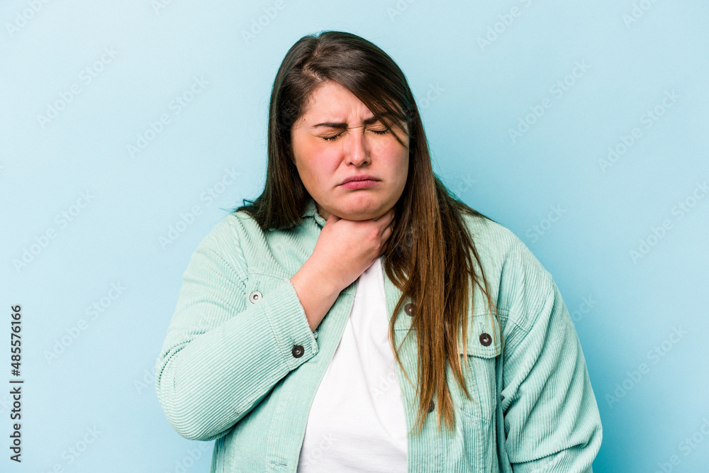 Young caucasian overweight woman isolated on blue background suffers pain in throat due a virus or infection. Young caucasian overweight woman isolated on blue background suffers pain in throat due a virus or infection.