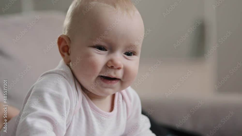 Close up nice little caucasian newborn baby funny smiling at home at clinic child girl boy small kid happy pediatrics childcare toddler health diapers adoption parenthood childhood innocence concept Close up nice little caucasian newborn baby funny smiling at home at clinic child girl boy small kid happy pediatrics childcare toddler health diapers adoption parenthood childhood innocence concept