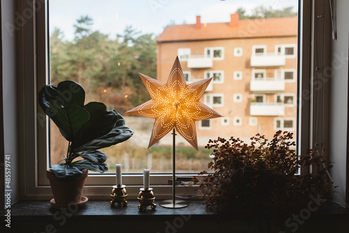 Illuminated star on windowsill photo