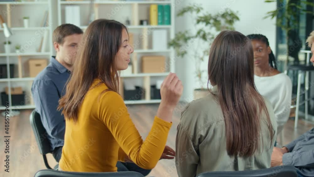 Young Mixed-race People Hug Each Other For Support, Comfort, Help with a Psychological Problem During a Group Therapy Session. The Concept of Psychological Recovery, Compassion and Empathy. Young Mixed-race People Hug Each Other For Support, Comfort, Help with a Psychological Problem During a Group Therapy Session. The Concept of Psychological Recovery, Compassion and Empathy.