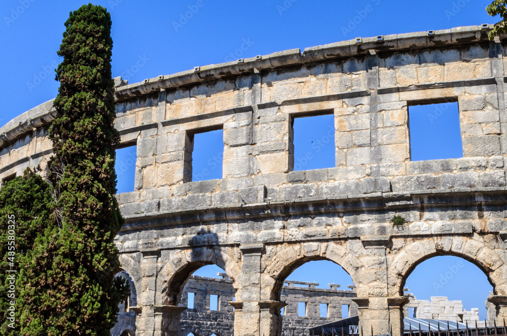The Pula Arena Roman Amphitheatre. Restored Arched Walls of the Ancient Monument. Located in Pula, Croatia on a Sunny Day with Blue Sky