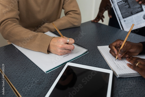 Mid section of women writing photo