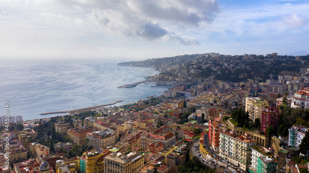 Aerial view of the city of Naples and the seafront of Mergellina on a sunny day.  The Posillipo district in the background.
