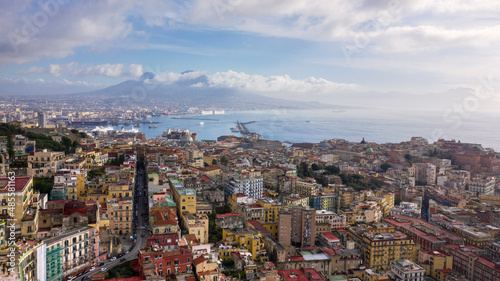Fototapeta Naklejka Na Ścianę i Meble -  Aerial view of the city of Naples and the harbour on a sunny day. The volcano Vesuvius in the background.