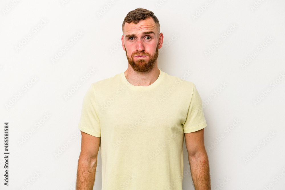 Young caucasian man isolated on white background blows cheeks, has tired expression. Facial expression concept. Young caucasian man isolated on white background blows cheeks, has tired expression. Facial expression concept.