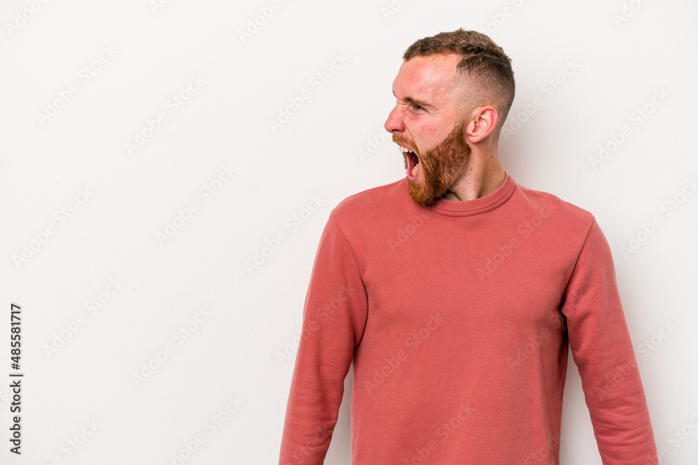 Young caucasian man isolated on white background shouting very angry, rage concept, frustrated. Young caucasian man isolated on white background shouting very angry, rage concept, frustrated.