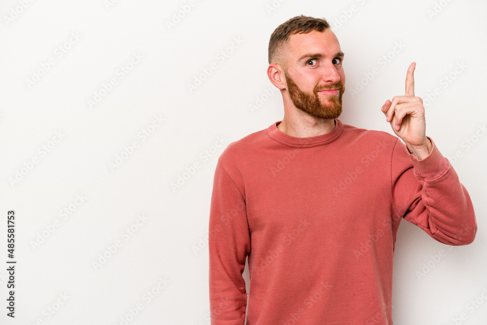 Young caucasian man isolated on white background showing number one with finger. Young caucasian man isolated on white background showing number one with finger.