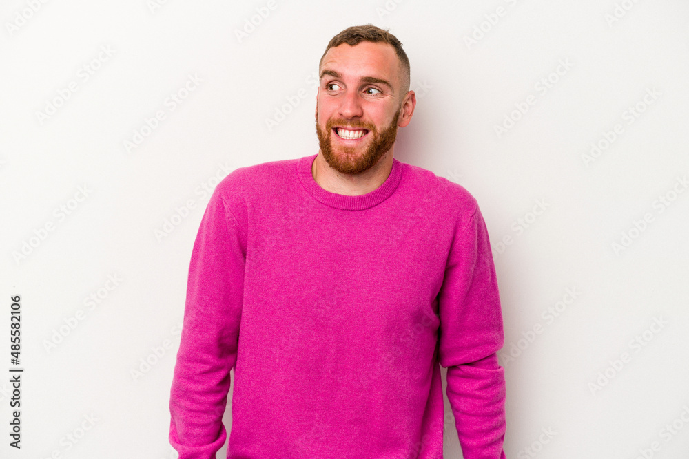 Fototapeta premium Young caucasian man isolated on white background laughs and closes eyes, feels relaxed and happy.