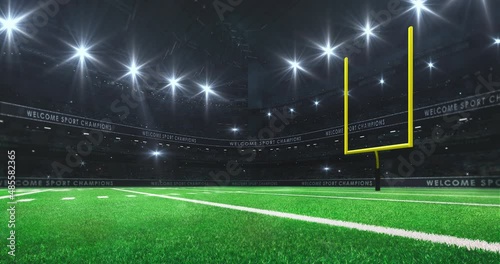 American football stadium with yellow goal post on side, grass field and glowing spotlights and camera flashes. Sport advertisement 4K Video loop. photo