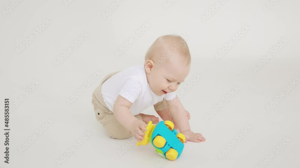 toddler boy playing with car toy on white background isolated toddler boy playing with car toy on white background isolated