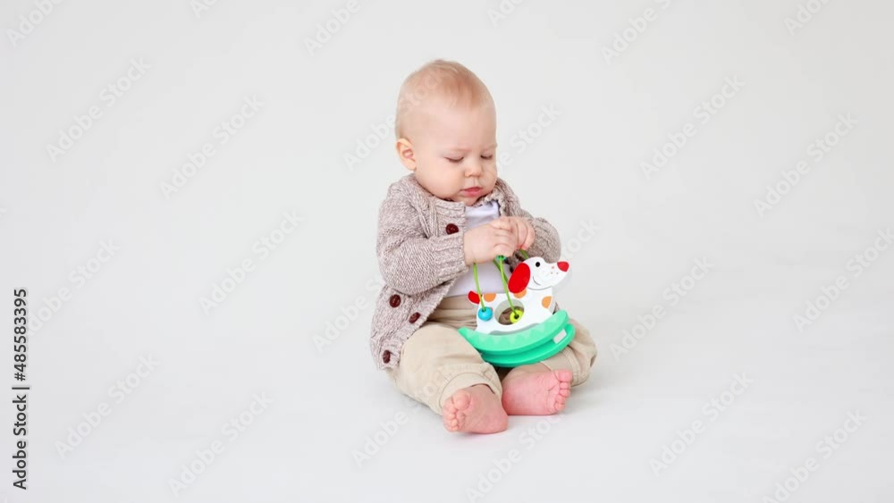 baby boy playing an educational toy on a white background isolated baby boy playing an educational toy on a white background isolated
