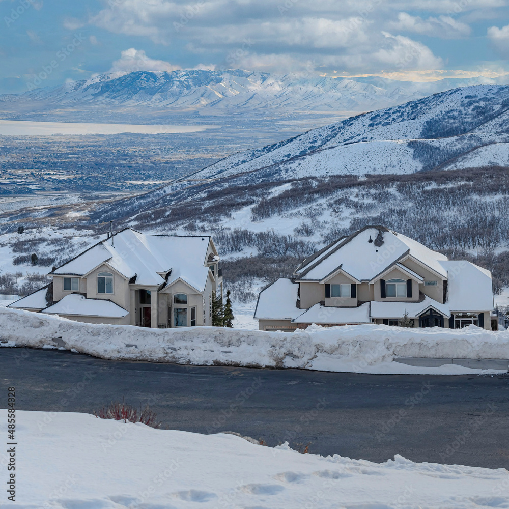 Square White puffy clouds Uphill snowy residential area at Draper in Utah with a view of W Square White puffy clouds Uphill snowy residential area at Draper in Utah with a view of W