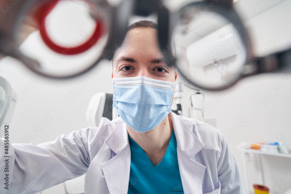 Professional ophthalmologist diagnosing the vision of patient Professional ophthalmologist diagnosing the vision of patient