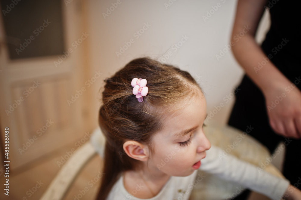 Mother and daughter weekend together at home, mom making hairstyle. Mother and daughter weekend together at home, mom making hairstyle.