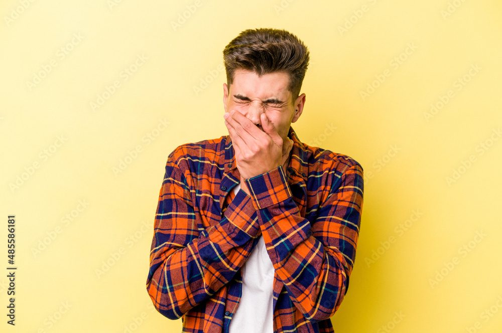 Young caucasian man isolated on yellow background suffers pain in throat due a virus or infection.
