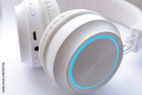 White wireless headphones on white background close up