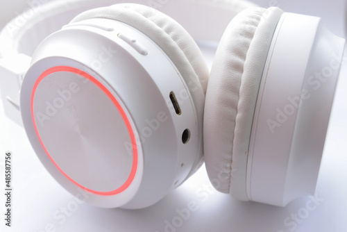 White wireless headphones on white background close up