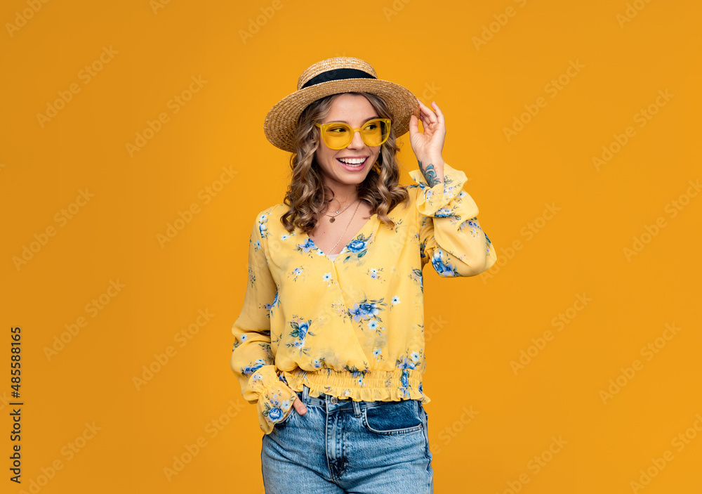 stylish happy smiling blond woman on vacation in straw on yellow background stylish happy smiling blond woman on vacation in straw on yellow background