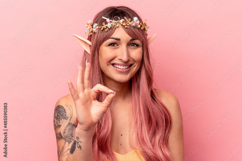 Young caucasian elf woman isolated on pink background cheerful and confident showing ok gesture. Young caucasian elf woman isolated on pink background cheerful and confident showing ok gesture.