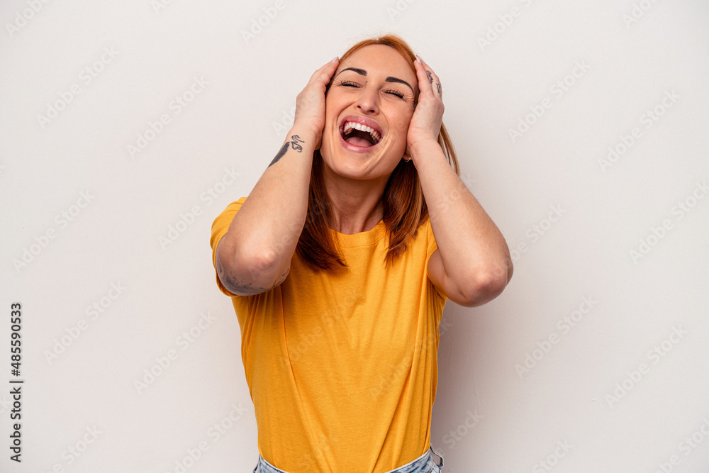 Young caucasian woman isolated on white background laughs joyfully keeping hands on head. Happiness concept. Young caucasian woman isolated on white background laughs joyfully keeping hands on head. Happiness concept.