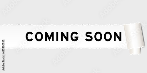 Ripped gray paper background that have word coming soon under torn part