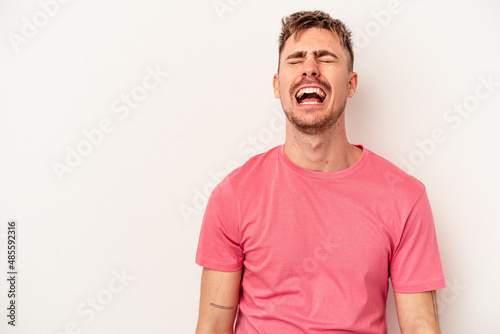 Young caucasian man isolated on white background throwing a punch, anger, fighting due to an argument, boxing.