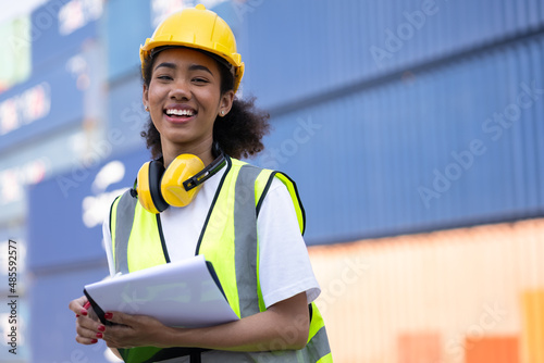 Portrait happy foreman, engineer use clipboard at container ship