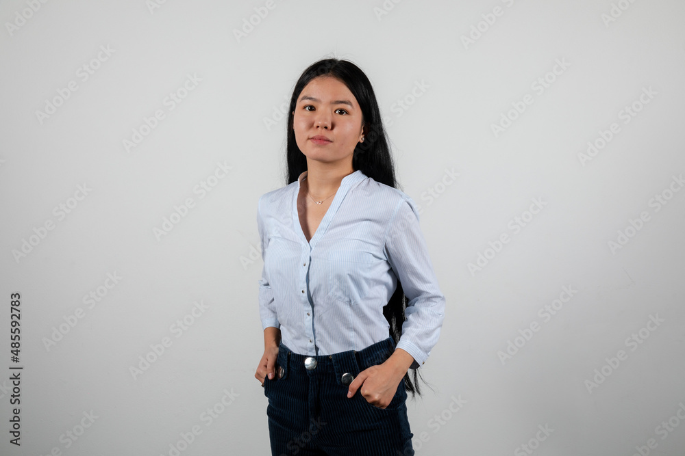 Young woman in a white shirt posing isolated on a white background Young woman in a white shirt posing isolated on a white background