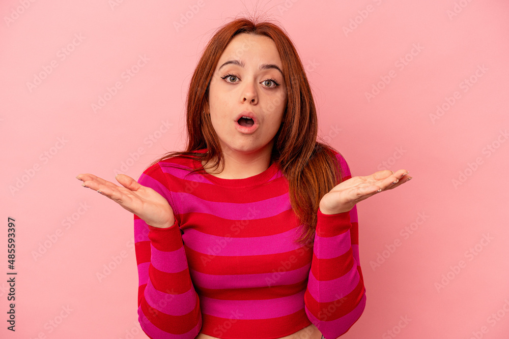 Young caucasian woman isolated on pink background surprised and shocked. Young caucasian woman isolated on pink background surprised and shocked.
