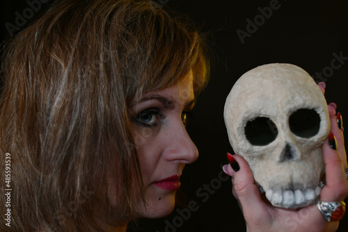 portrait of a witch woman with a skull in her hand photo