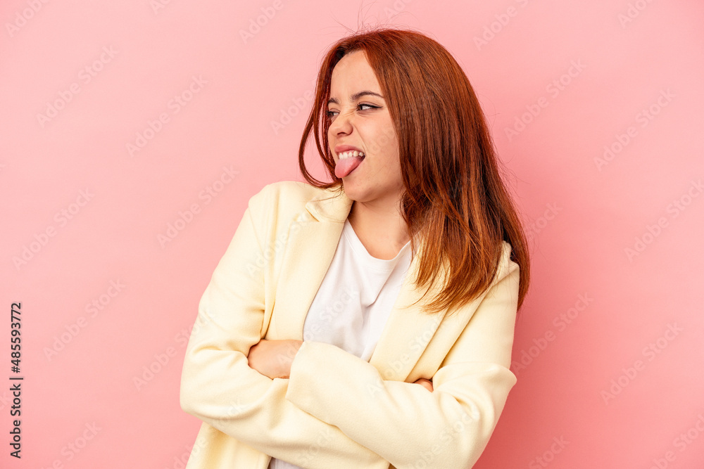 Young caucasian woman isolated on pink background funny and friendly sticking out tongue. Young caucasian woman isolated on pink background funny and friendly sticking out tongue.