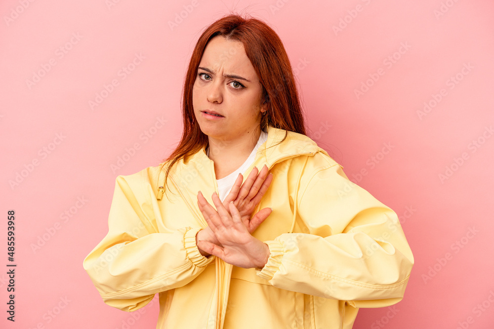 Young caucasian woman isolated on pink background doing a denial gesture