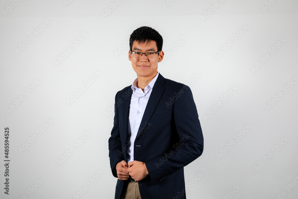 Young smiling asian man wearing glasses, black office jacket and white shirt