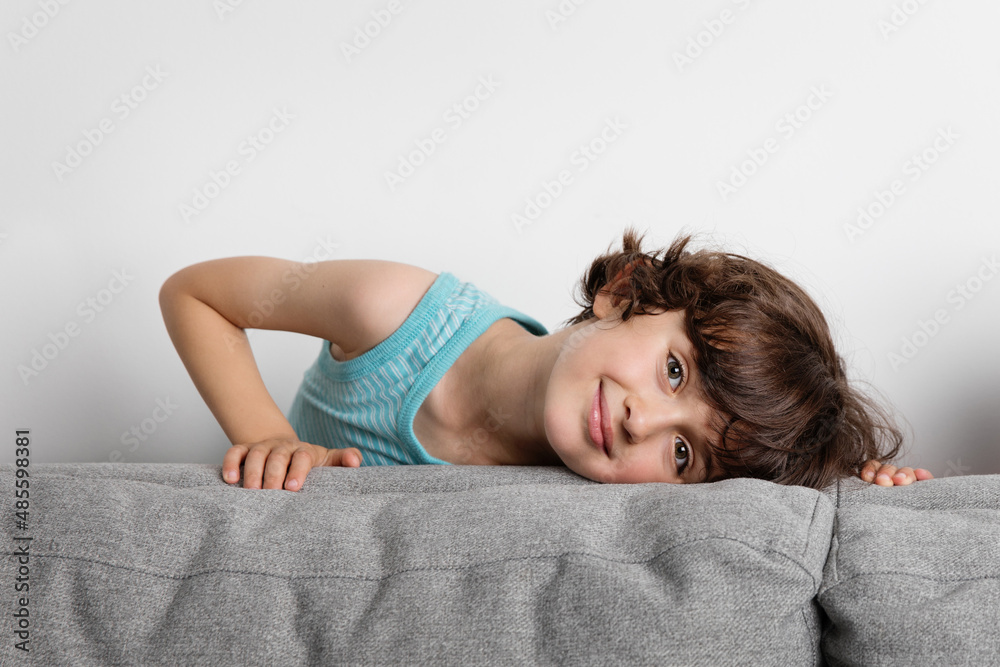 Portrait of beautiful young boy leaning on couch Portrait of beautiful young boy leaning on couch