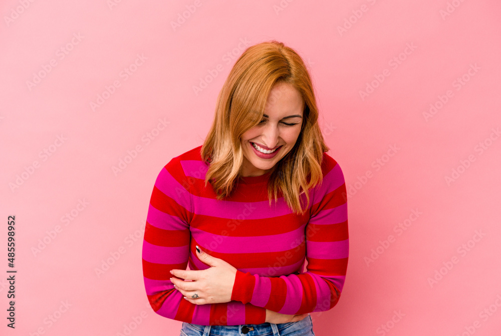 Young caucasian woman isolated on pink background laughing and having fun. Young caucasian woman isolated on pink background laughing and having fun.